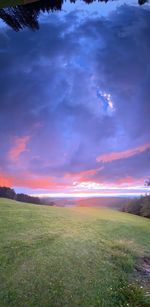 Scenic view of field against sky during sunset