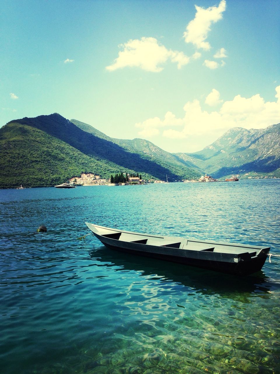 mountain, water, nautical vessel, mountain range, sky, boat, transportation, tranquil scene, scenics, tranquility, lake, mode of transport, beauty in nature, nature, cloud - sky, moored, waterfront, sea, cloud, blue