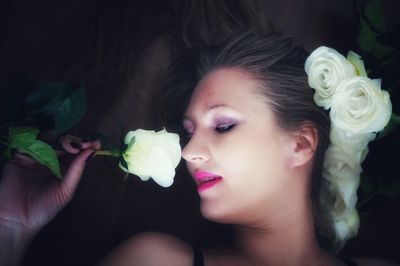 Directly above shot of woman smelling rose