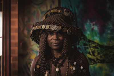 Portrait of man wearing headwear against wall
