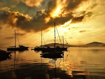 Sailboat in sea at sunset