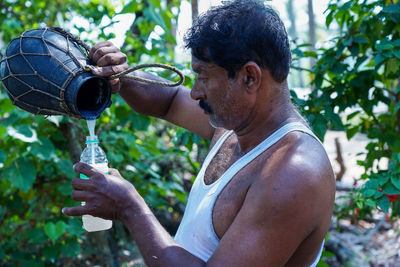 Side view of man drinking water