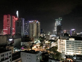 Illuminated cityscape against sky at night