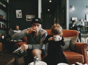 Father and daughter drinking coffee in cafe