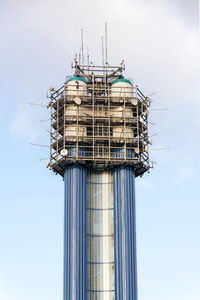 Low angle view of crane against sky