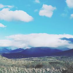 Scenic view of landscape against cloudy sky