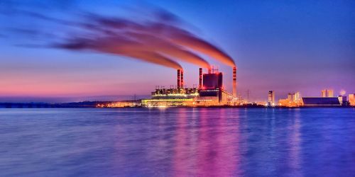 Factory against sky at night