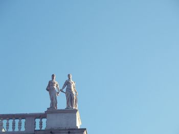 Low angle view of statue against clear blue sky