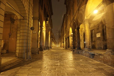 Empty illuminated street at night