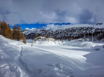 Snow covered landscape against sky