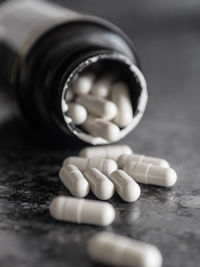 Close-up of pills with bottle