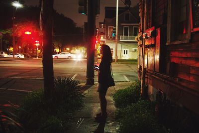 Blurred motion of people walking on road at night