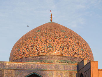 Low angle view of bell tower against sky