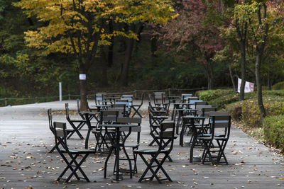 Empty chairs and table in park