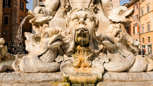 Close-up of statue against historic building