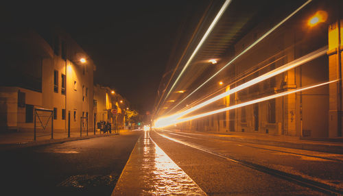 Light trails on road in city at night