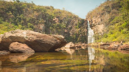 Scenic view of waterfall against sky