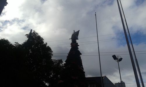 Low angle view of building against cloudy sky