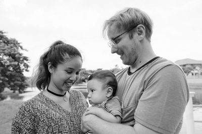 Portrait of father with daughter against clear sky