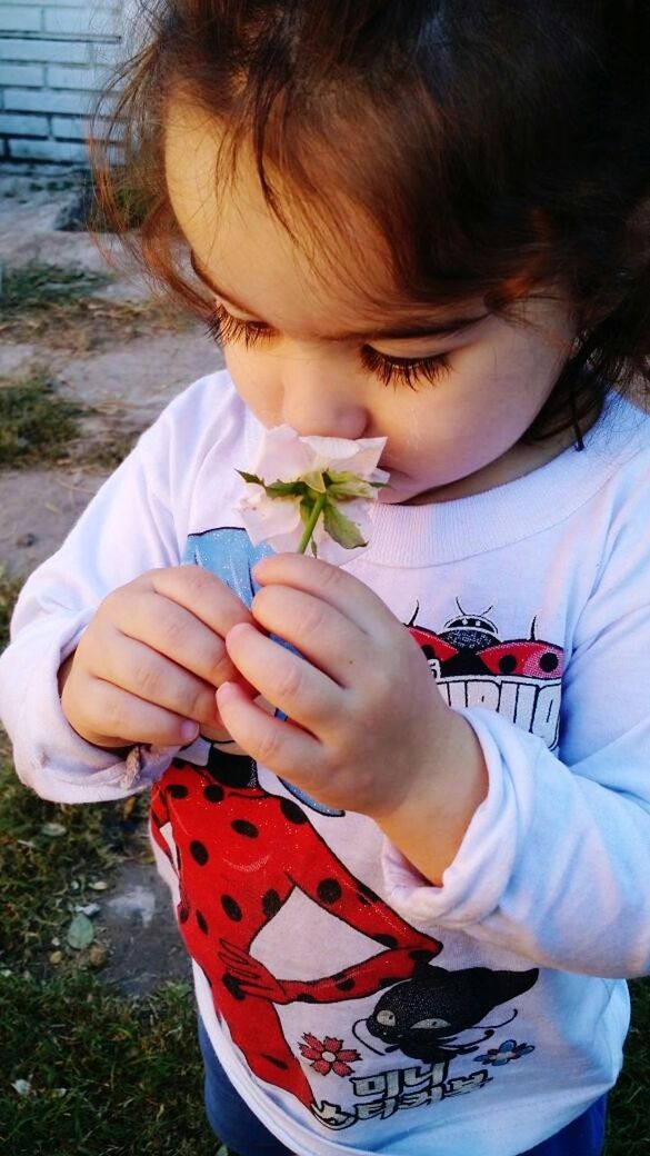 CLOSE-UP OF CUTE BOY HOLDING GIRL