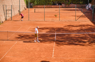 Man playing with ball in background