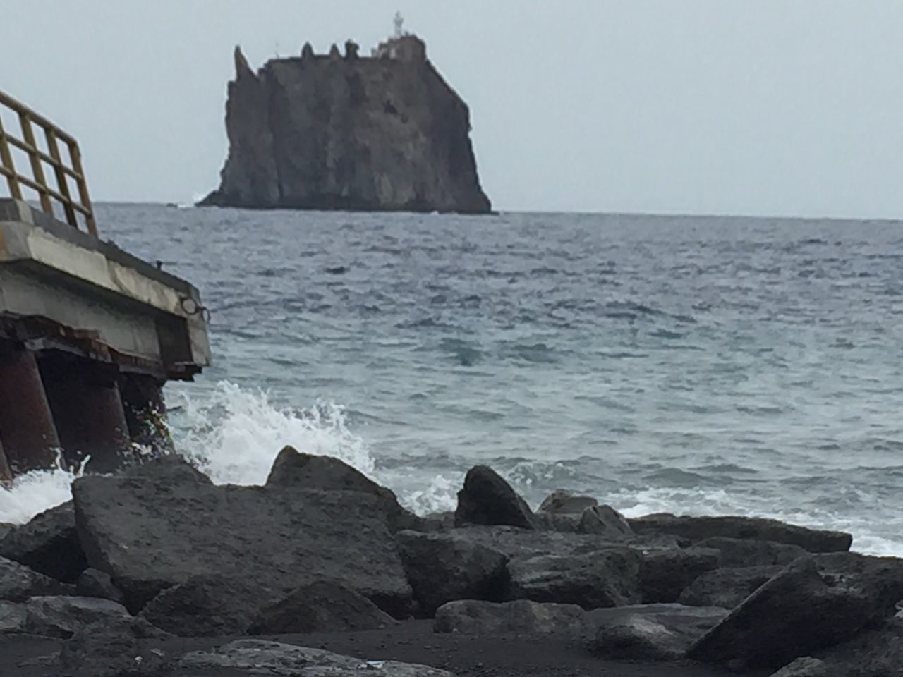 sea, water, horizon over water, rock - object, built structure, clear sky, scenics, architecture, sky, tranquil scene, tranquility, rock formation, nature, beach, beauty in nature, building exterior, shore, wave, day, rock