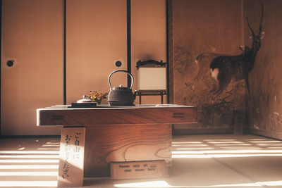 Electric lamp on table against wall at home