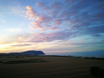 Scenic view of field against sky during sunset
