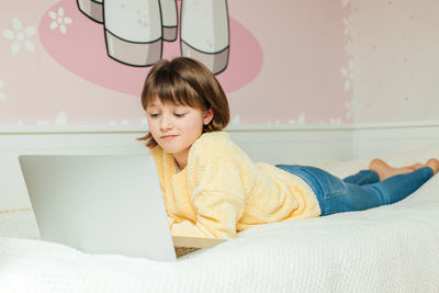 Girl using laptop at home