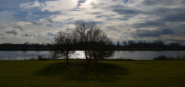 Scenic view of lake against cloudy sky