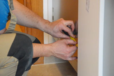 Midsection of man renovating home