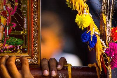 Close-up of hand holding religious equipment