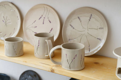 Ceramics with floral and natural patterns on the shelf of the shop. creative minimalistic handmade