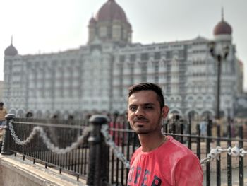 Portrait of young man against taj mahal hotel in city