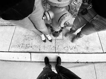 Low section of people standing on footpath