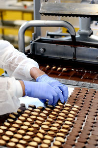 Worker puts almonds on chocolates
