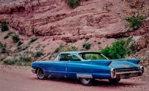 Side view of car parked on road