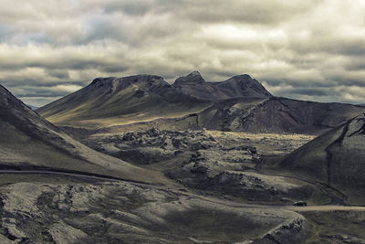 Scenic view of mountains against cloudy sky