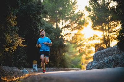 Young man jogging on road