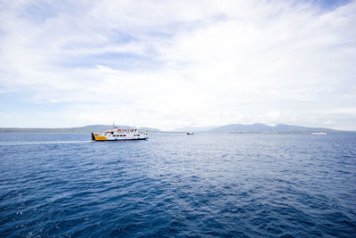 Boat sailing in sea against sky