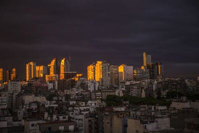 Aerial view of buildings in city against sky