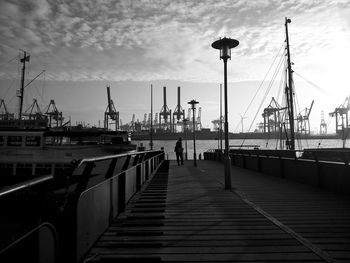 Man walking on pier at dock