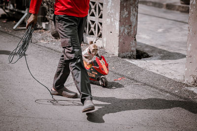 Low section of people walking on street