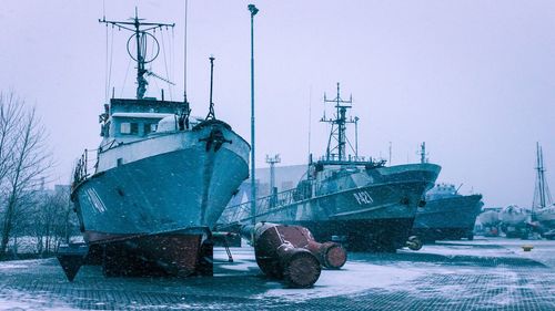 Ship moored in sea against clear sky during winter