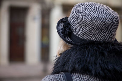 Rear view of woman wearing hat in city