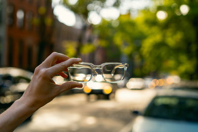 Close-up of hand holding glass against blurred background