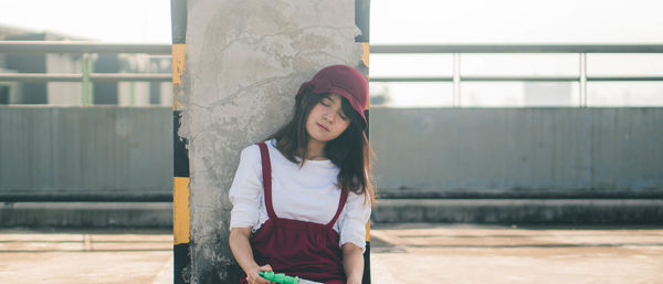 Portrait of beautiful young woman standing outdoors