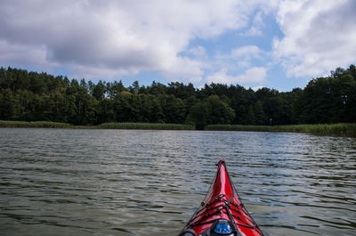 Cropped image of boat on river against sky