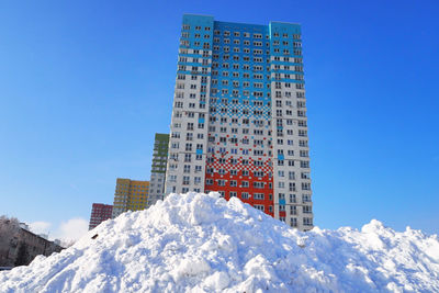 Low angle view of building against clear sky during winter