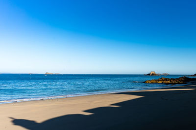 Scenic view of sea against clear blue sky